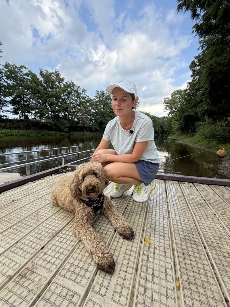 Owner and dog on an outdoor boardwalk
